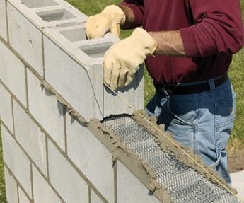 An Easy Way to Build Retaining Walls: Leave the Concrete in the Bag, Stack Like Legos, Wet With a Hose