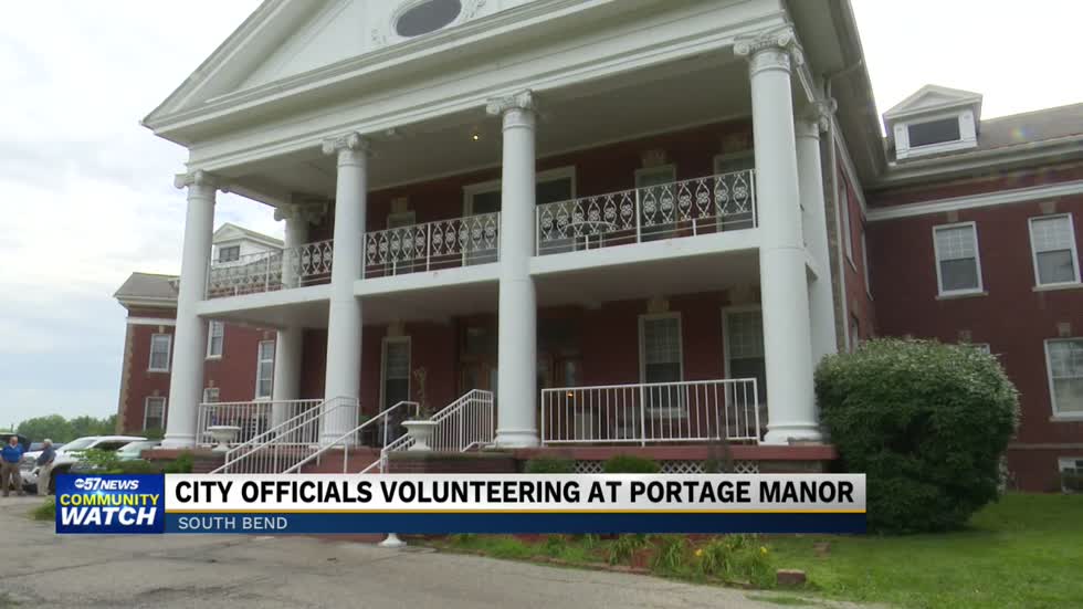 City officials and volunteers kick off day one of volunteer landscaping project at Portage Manor
