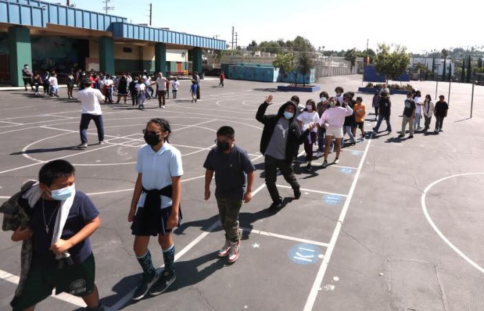 LOS ANGELES, CA - AUGUST 31, 2022 - - Students return to class after a midmorning recess at Lockwood Elementary School on August 31, 2022. With temperatures rising in Los Angeles the principal of the school decided that students would not be allowed to play in the yard in the afternoon due to extreme hot weather.  Lockwood Elementary School is the number one school in LAUSD's greening index meaning it is the most in need of green space out of all schools.  (Genaro Molina / Los Angeles Times) ATTENTION PRE-PRESS: PLEASE DO NOT LIGHTEN FACES AS TO NOT IDENTIFY STUDENTS.